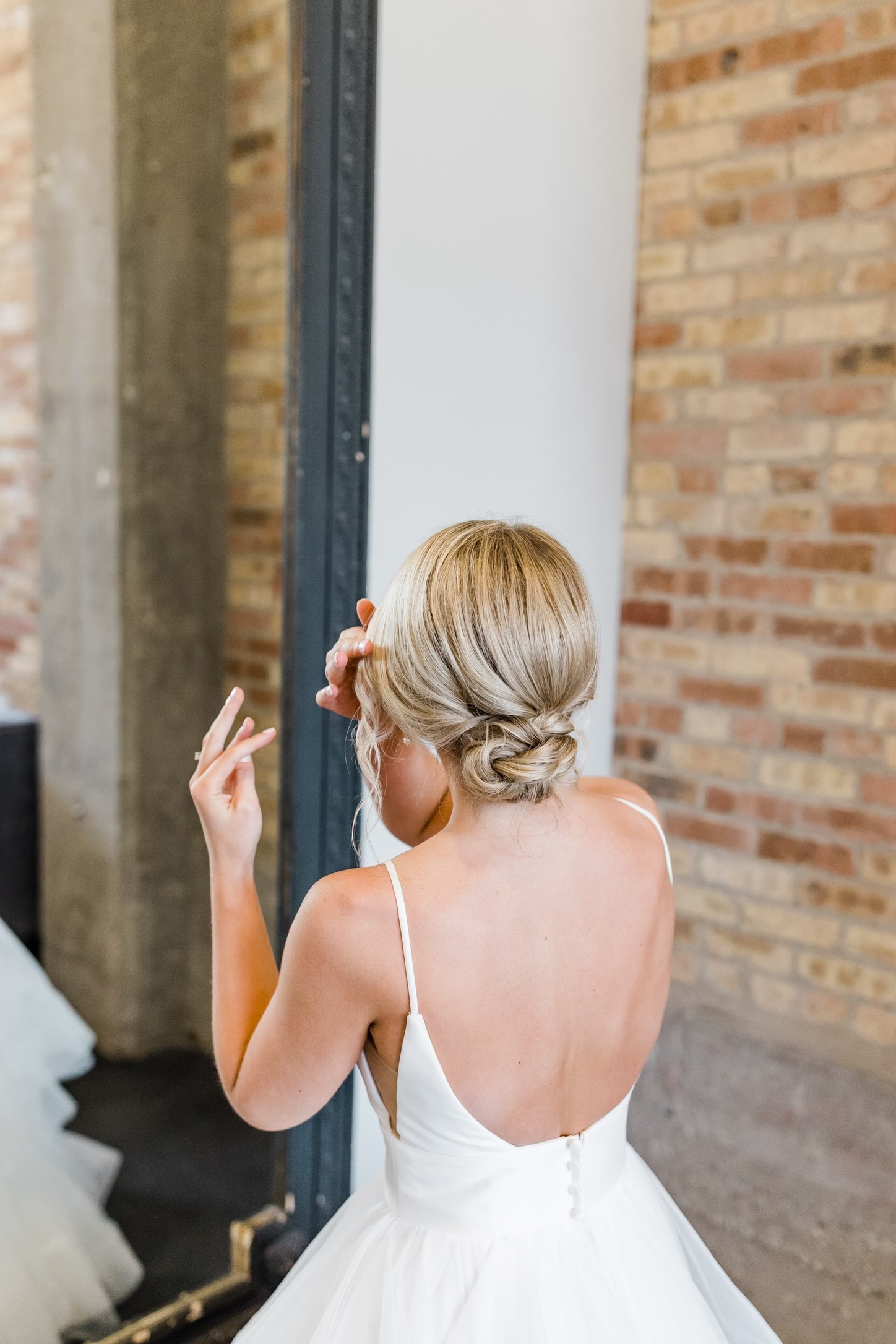 Bridal in gown admiring her Parella beauty glam in the mirror